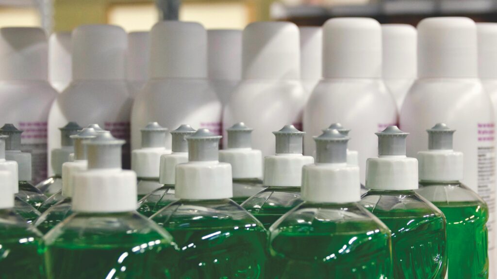 Close-up view of green liquid in bottles, ideal for household cleaning and stocks.